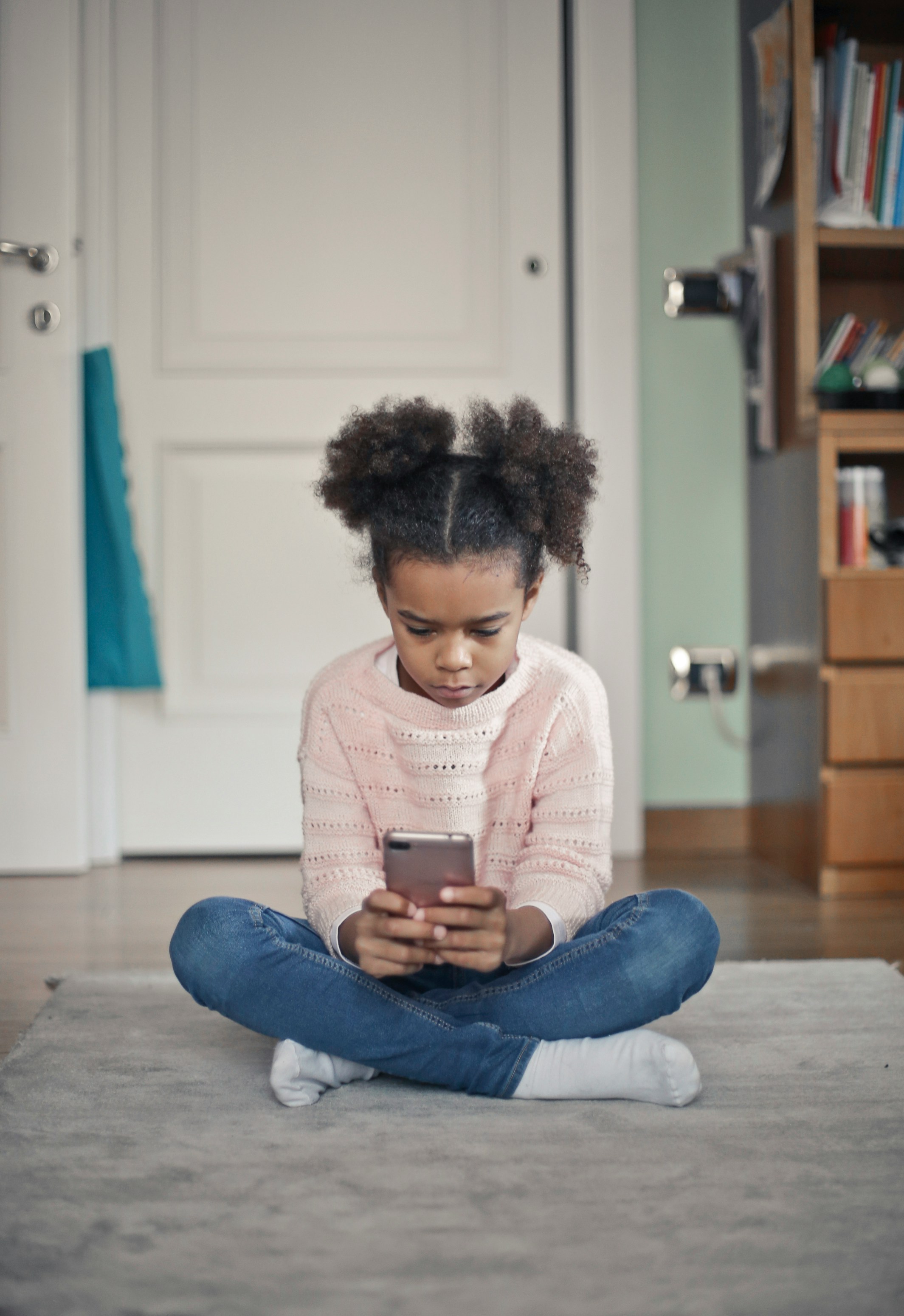 Child using a smartphone at home
